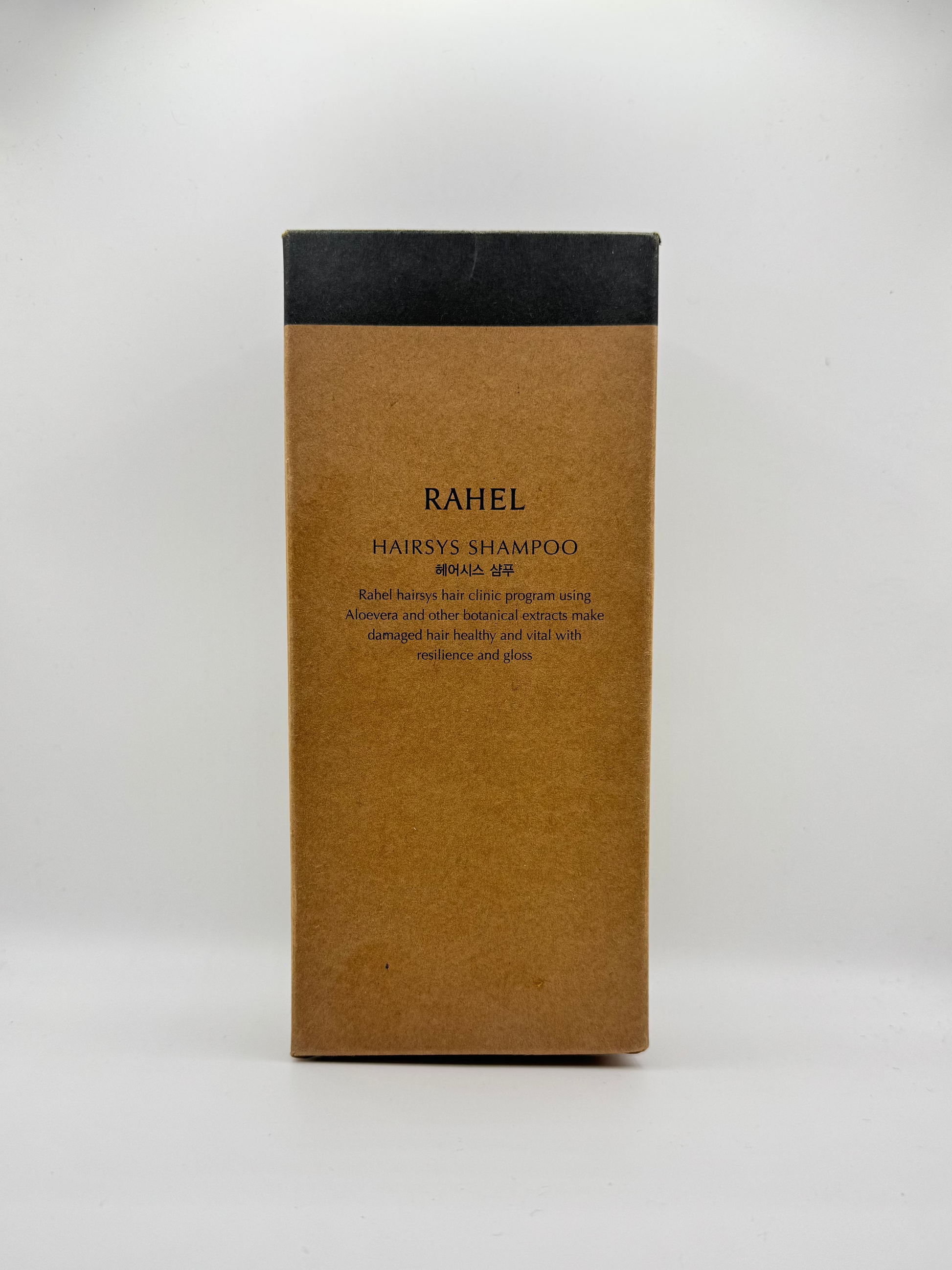 Brown rectangular box with black top labeled 'RAHEL' on a white background